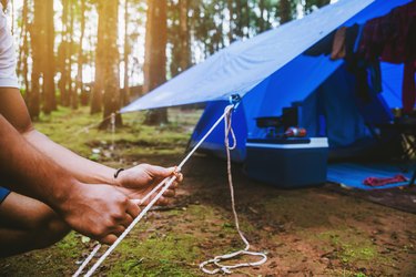 Midsection Of Man Holding Tent