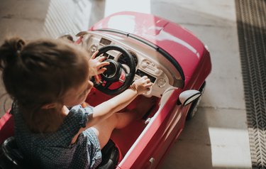 Child inside toy car