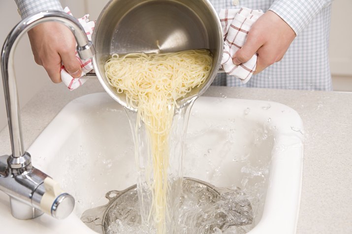 Person draining spaghetti