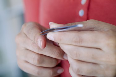 Woman removing a splinter.