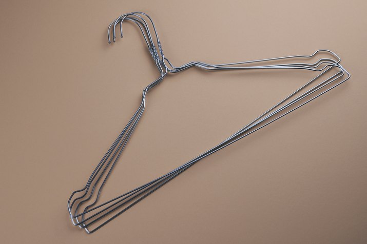 Wire hangers on beige background