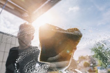 Man Washing Car Seen Through Windshield