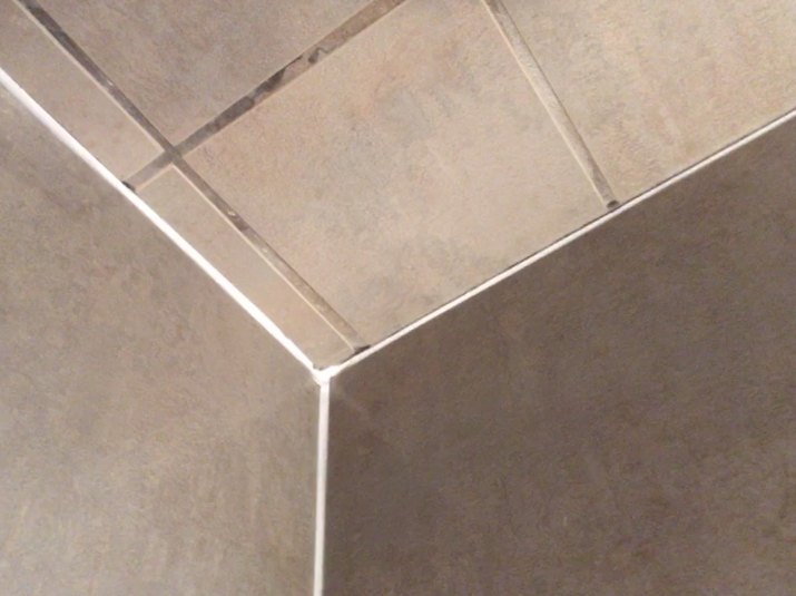 fresh caulk on shower tile