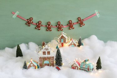 Gingerbread garland hanging above snowy gingerbread village