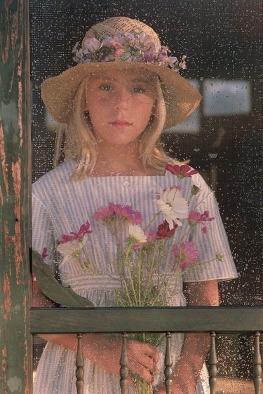 Portrait of girl through screen door