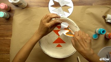 Using stencil to paint DIY desert-style baskets.