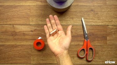 Copper coupling to use as wick holder for DIY concrete tabletop tiki torches out of used glass bottles.