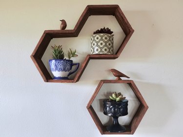 DIY hexagon, honeycomb shelves made using popsicle sticks, hot glue, and wood stain.