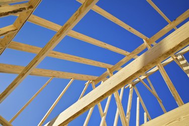 New construction home framing against blue sky