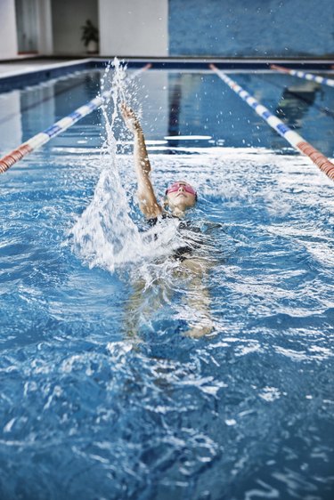 Woman swimming in indoor pool