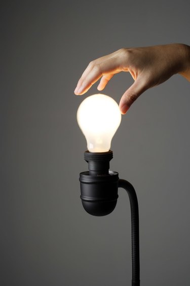 Hand on light bulb