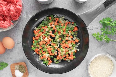 Cook onions, carrots and bell peppers