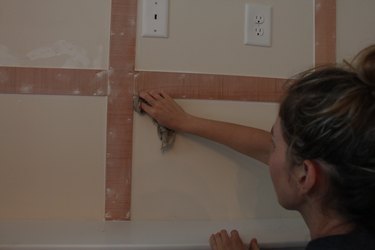 Wiping away excess caulk