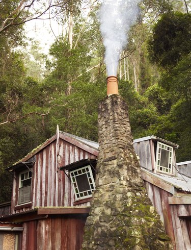 Country home with smoking chimney pot