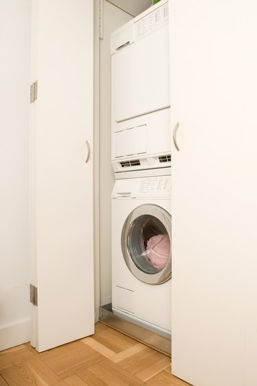 Washer and dryer stacked in closet