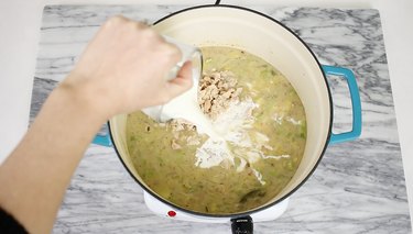 Adding clams and cream to pot