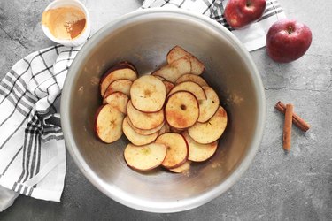 Toss apple slices with cinnamon and nutmeg