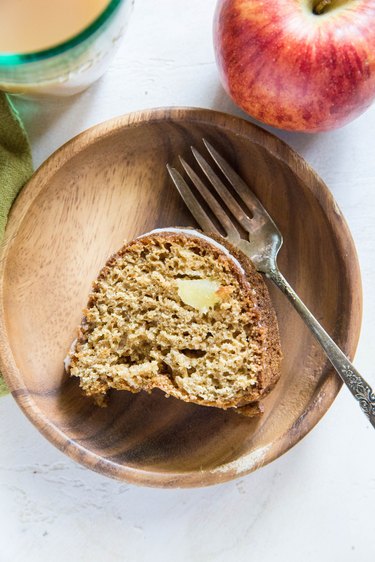 A slice of apple cider cake on a plate