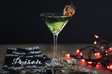 green caramel apple martini garnished with shrunken head