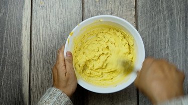 Mixing ingredients for deviled egg Easter chicks.