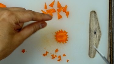 Cutting feet from carrot chips for deviled egg Easter chicks.