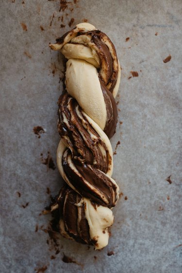 Braid the dough pieces together to form a log shape.