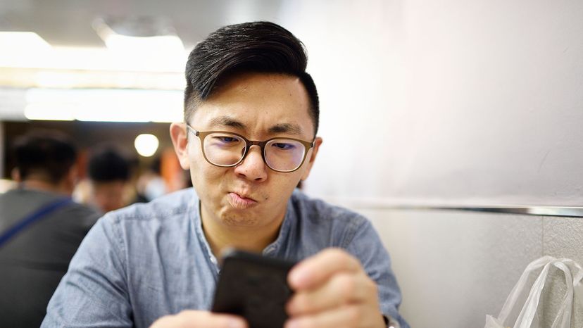 asian man on phone upset