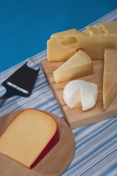 assorted cheese on cutting boards