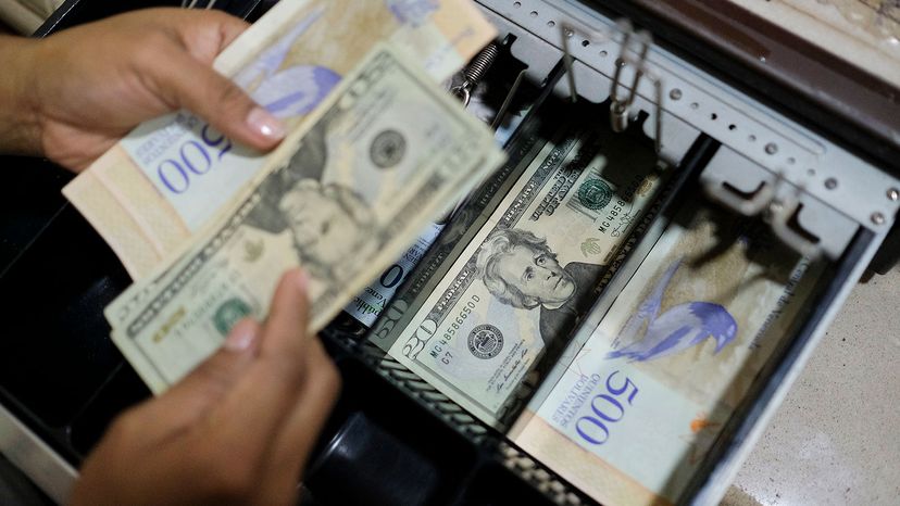 cash register drawer in Venezuela, U.S. 20 dollar bills.