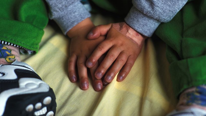 child with blue fingers