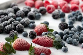 Freeze fresh fruit flat on a cookie sheet. Once solid, transfer the food to plastic bags for easy storage.